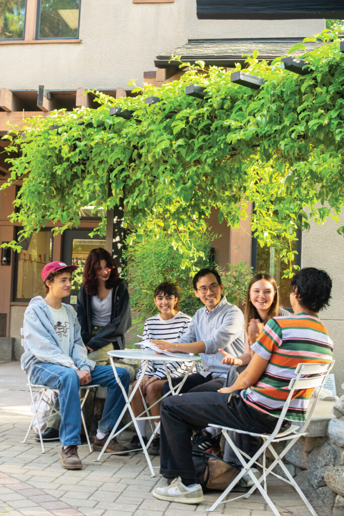 Director of DEIJ and Community Engagement RJ Sakai (third from right) meets with high school student affinity conveners.